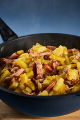 Potatoes and ham in a wok