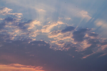 Summer evening sky in the picturesque clouds, lit by the rays of the setting sun.