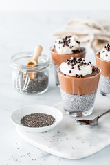 Healthy chocolate mousse chia pudding glasses, ready for eating.