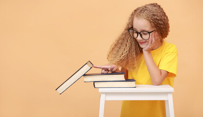 Back to school. School education and literacy concept with schoolgirl in glasses with curly hair,...