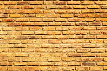 Wall of brown, red and orange bricks. Pattern. Advertising space. Design element. Background. Horizontal.