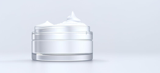 Open glass cosmetic jar with cream.