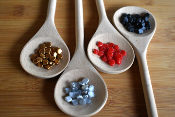 wooden spoons with seed beads on a surface
