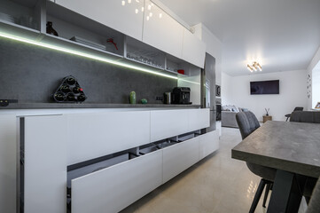 White modern kitchen with dark grey granite counter top