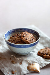 Homemade cookies with cereal and seeds, bowl on a table, made with love