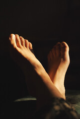 Fototapeta premium Feet of a girl in a sun light