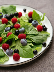 Healthy salad with fresh New Zealand spinach, blueberries, raspberries and blackcurrants