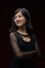 12 year old Mexican  girl portrait isolated on red background wearing glasses