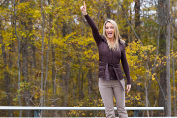 Gorgeous Blonde Model Enjoying The Fall Foliage Outdoors While Cheering On Her Favorite Team