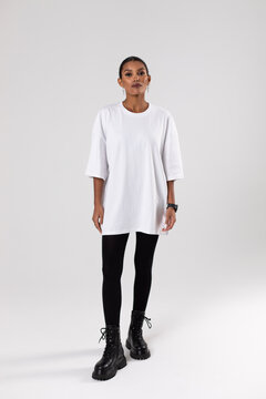 African american woman in oversized white t-shirt. Mock-up.