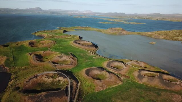 4K drone aerial footage over volcanic pseudo craters Skutustadagigar in lake Myvatn. Huge cones of pseudo craters on the Icelandic shore. Aerial of Skutustadagigar Pseudocrater Area in Iceland.