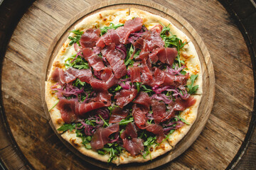 Hearty pizza with pieces of meat. Cheese pizza. Appetizing piece of pizza.