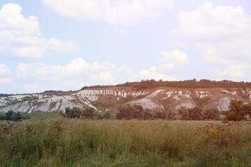 Ancient multimillion chalk mountains on the steppe surface of earth. White chalk mountains in the Dvurechansky park reserve in Ukraine