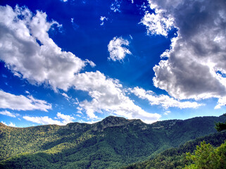 Mountain ridge under cloudy blue sky