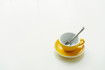 Yellow coffee cup set on white table