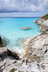 Half Moon Cay Island Rocky Coastline And Dark Clouds