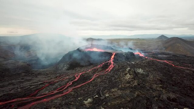4K Aerial drone footage of Fagradalsfjall active volcano eruption in Geldingadalir, Reykjanes, Iceland. River Of Hot Lava Flowing down the hill surrounded by smoke. Iceland Volcanic eruption Grindavik