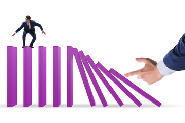 Businessman in domino effect concept