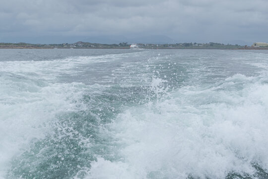 sea whirpool waves leftafter fast goig ship .