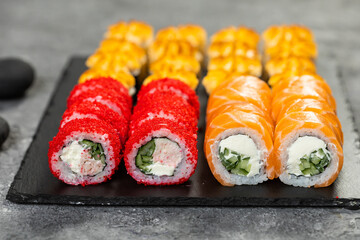 Sushi set. Philadelphia roll, california, unagi with fresh ingredients on black background. Sushi menu. Japanese asian food.