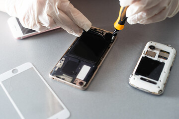 The technician repairing the smartphone's motherboard in the lab with copy space. the concept of...