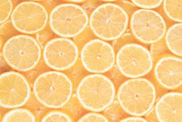A slices of fresh juicy yellow lemons.  Texture background, pattern.