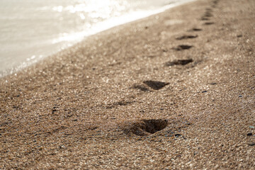 Human footprint on sand summer beach background with copyspace