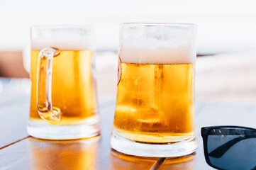 Glasses of cold craft light beer in open bar during summer vacation