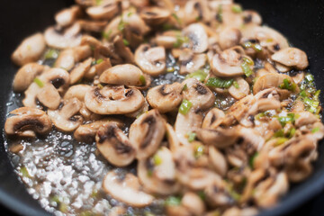 Cook champignon mushrooms in a pan with a dill