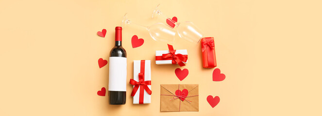Bottle of wine, glasses, letter and gifts for Valentines Day on color background, top view