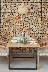 Beautiful table setting with mimosa flowers and candles in room