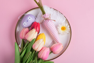 Easter decorations on the table, a white knitted napkin. Table decoration rabbit, carrot and painted eggs