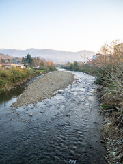 A shallow fast river. Stream with shallows. Fast river in the city. Concrete rapids on the river....