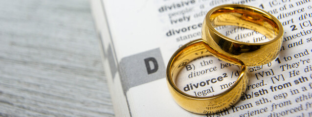 Divorce concept. Law and Justice background. Judge gavel on with two golden wedding rings