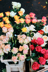 Multicolored roses close up. Flower market or florist shop
