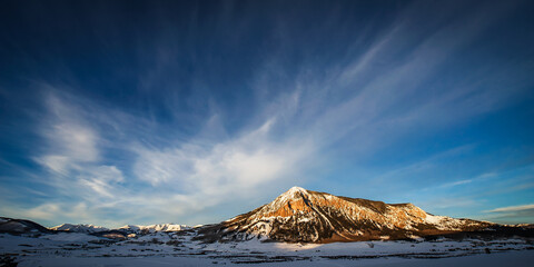 The evening sun shines on Mount Crested Butte in Colorado