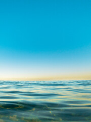 Naklejka na ściany i meble ocean surface with reflection of blue sky