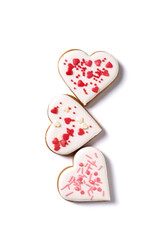 Tasty heart shaped cookies with colorful sprinkles on white background. Valentine's Day celebration