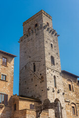 Fototapeta na wymiar Ancient medieval tower in the town center of San Gimignano, Tuscany, Italy