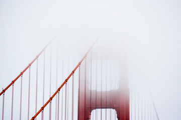 Fog enshrouds the Golden Gate Bridge in San Francisco California.
