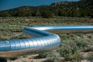 Geothermal steam pipeline across a desert.
