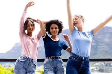 Obraz premium Image of three diverse women in t shirts with copyspace and denim trousers with nature background