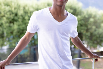 Fototapeta premium Image of african american man in white short sleeve t shirt with copyspace