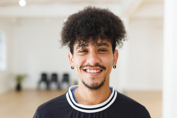 Image of happy biracial male hip hop dancer posing to camera