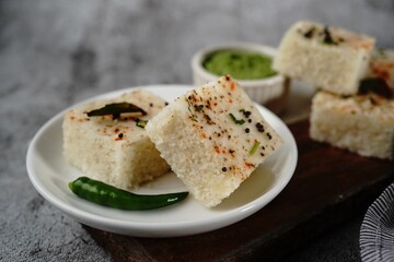 Spongy white dhokla - popular Gujarati steamed breakfast with rice or rava served with green chutney