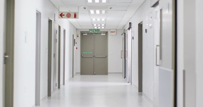 Video of brightly lit, clean, empty corridor in modern hospital, with copy space
