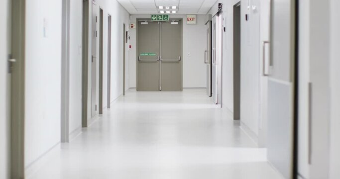 Video of brightly lit, clean, empty corridor in modern hospital, with copy space