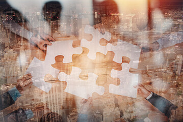 Teamwork of partners connect puzzle pieces as integration and startup - obrazy, fototapety, plakaty
