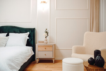 Luxury and stylish bedroom interior with king size bed, white bedding and modern light fixtures and beautiful nightstands