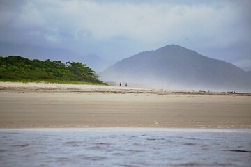 Bike standing on river side. Calm waters and green forest on opposite side. Itguare beach, Bertioga, Brazil